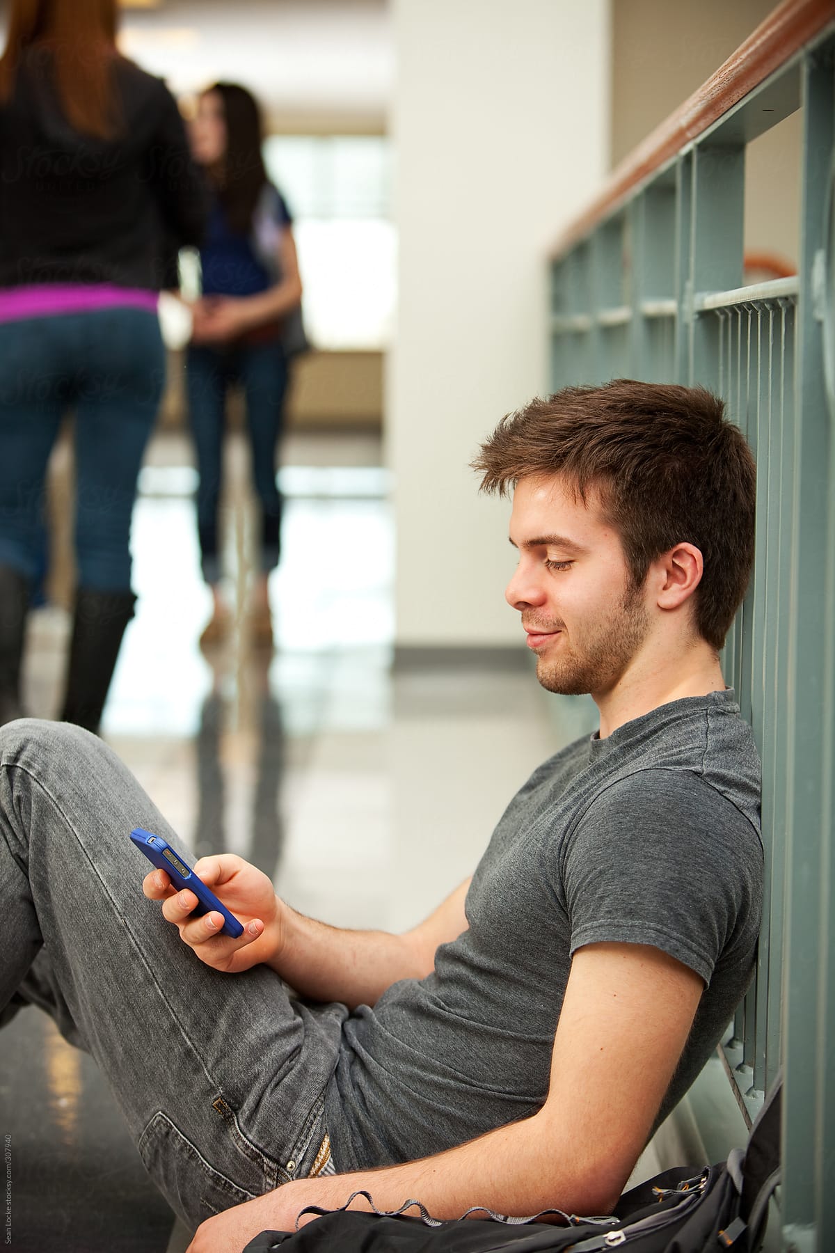 High School: Teen Male Texts Friends Between Classes