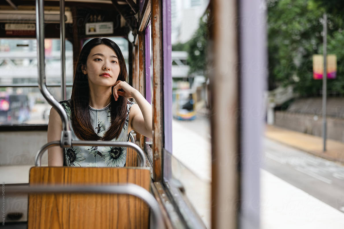 A woman sitting in a Ding Ding tram
