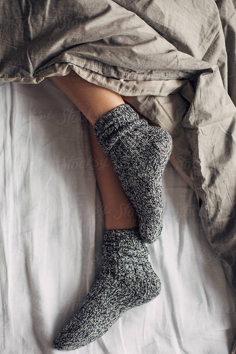 Woman Wearing Wool Socks Sleeping in Bed