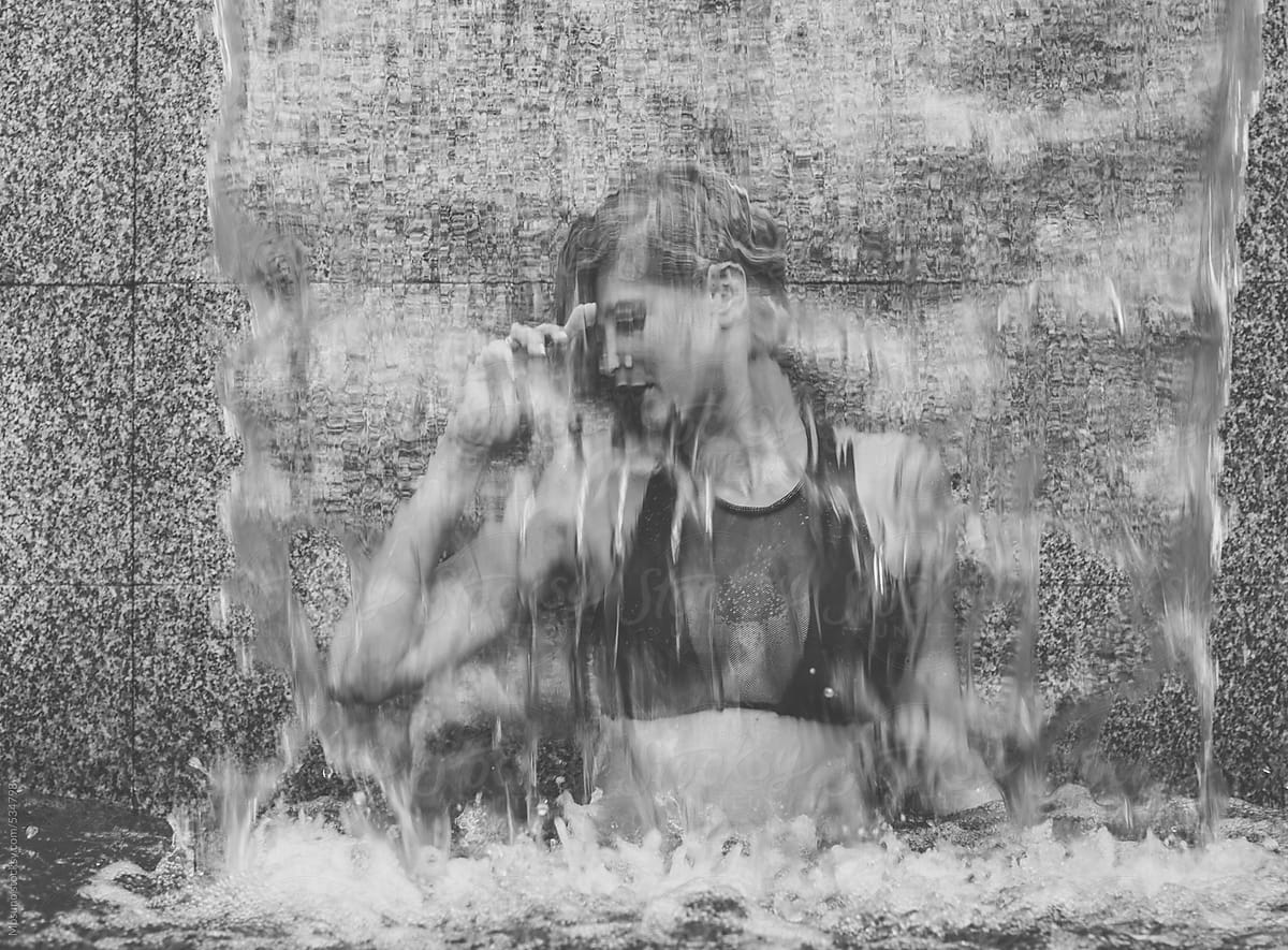 Woman Behind the Swimming Pool Waterfall