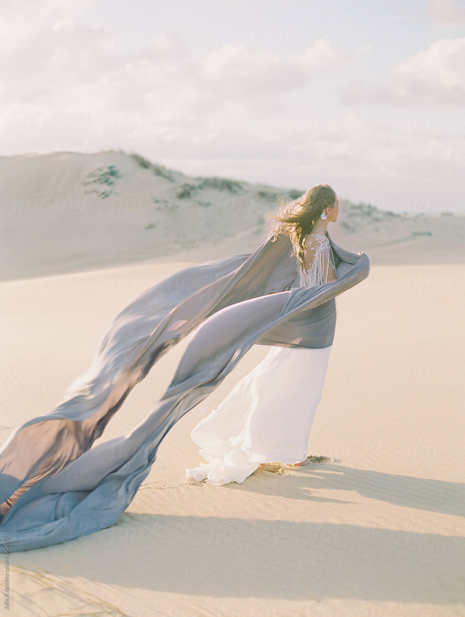 Blonde woman walks on desert sand