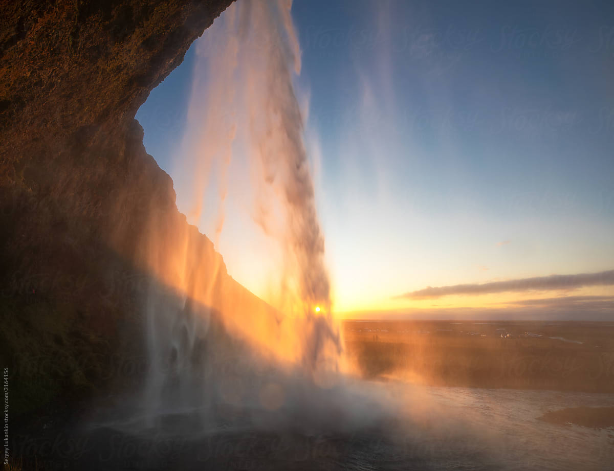 Landscape with a waterfall at sunset
