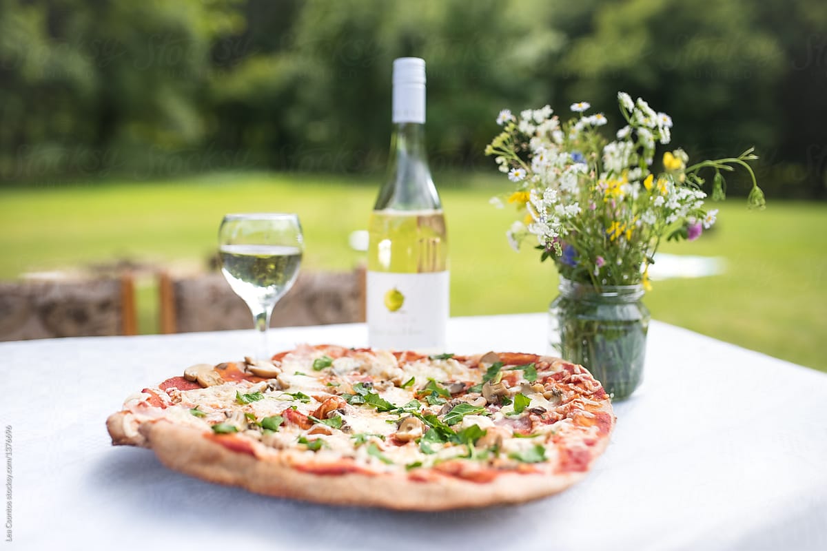 Home made pizza and wine outdoors in summer