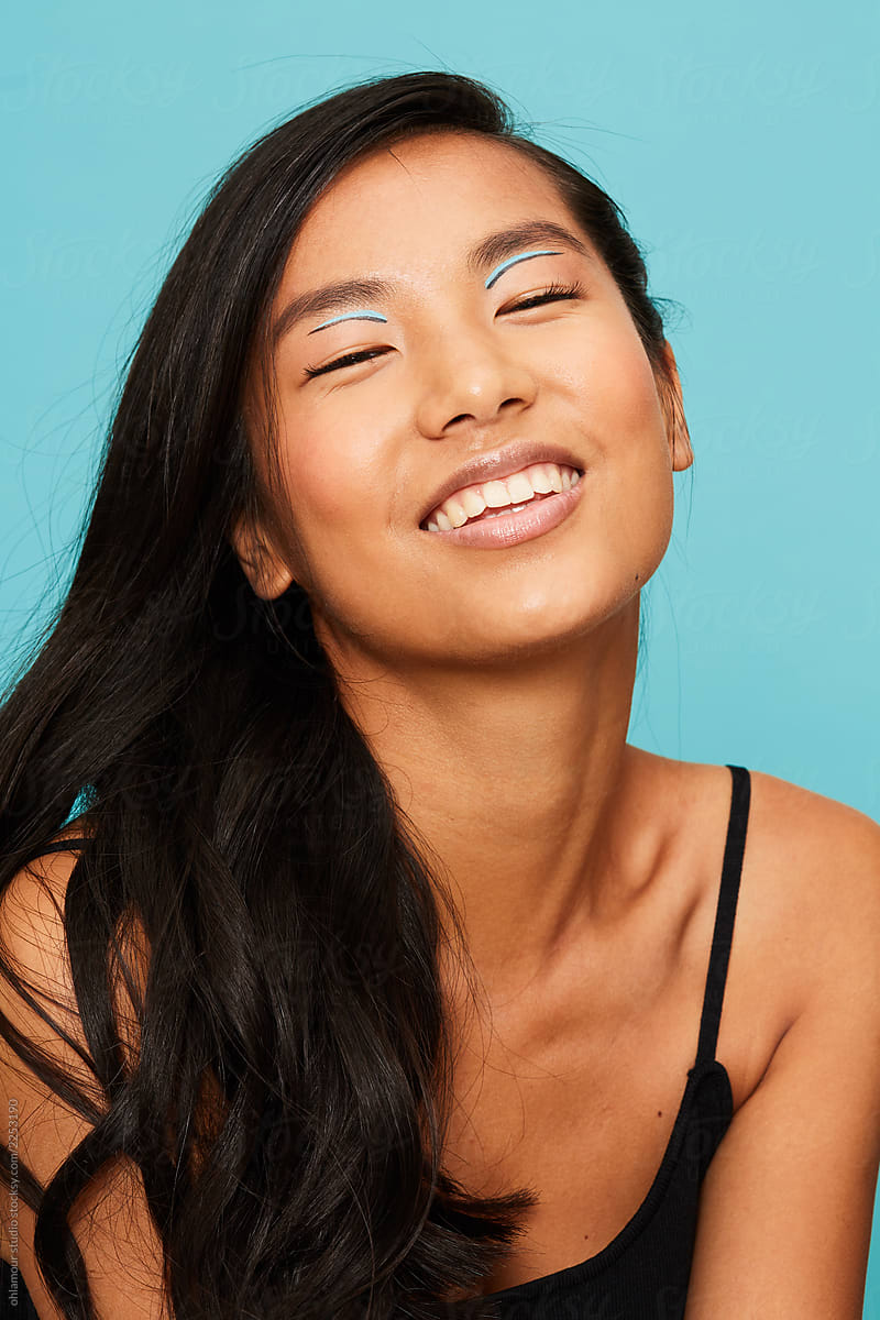 Asian Woman Portrait Smiling With Eyes Closed By Stocksy Contributor