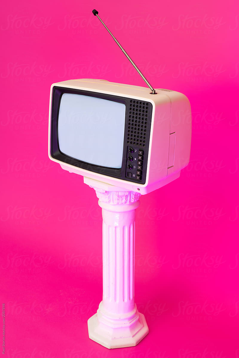 Old analog TV displaying noise against bright pink background. Vaporwave.