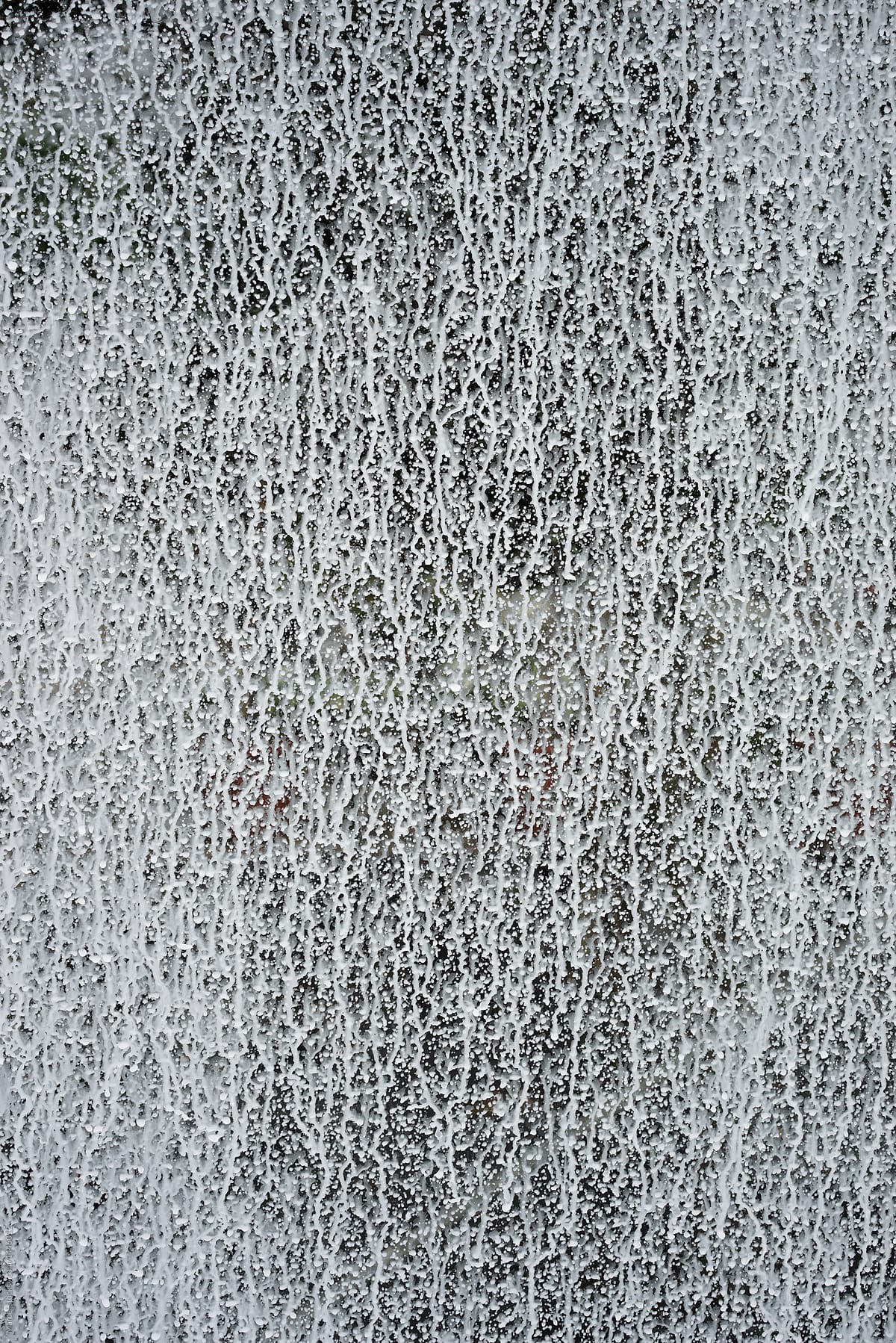 White liquid coating on a greenhouse