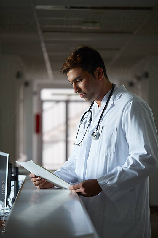Portrait of a doctor reading a diagnosis in a hospital hall