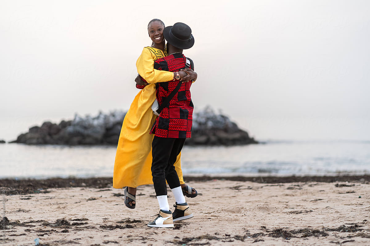 Senegalese Couple Embracing at Beach Sunset