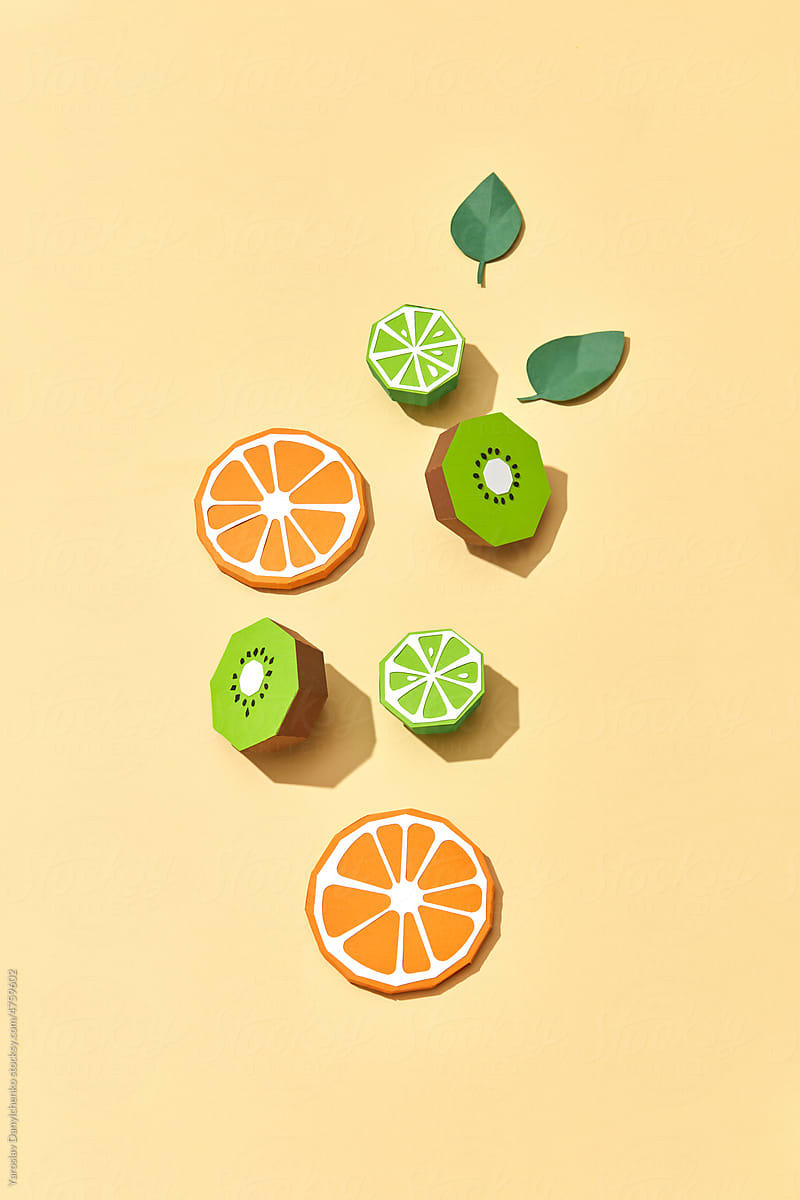 Handcraft paper slices of citrus and kiwi.