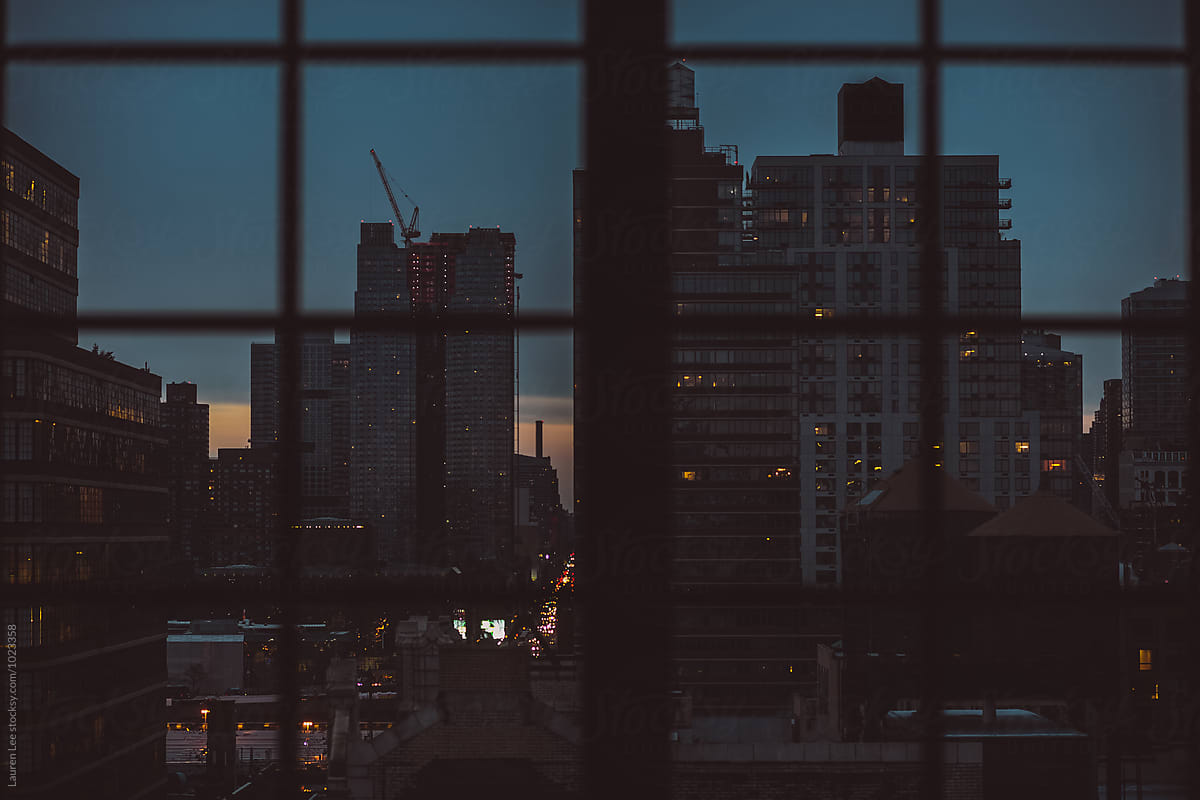 City seen through window at dawn