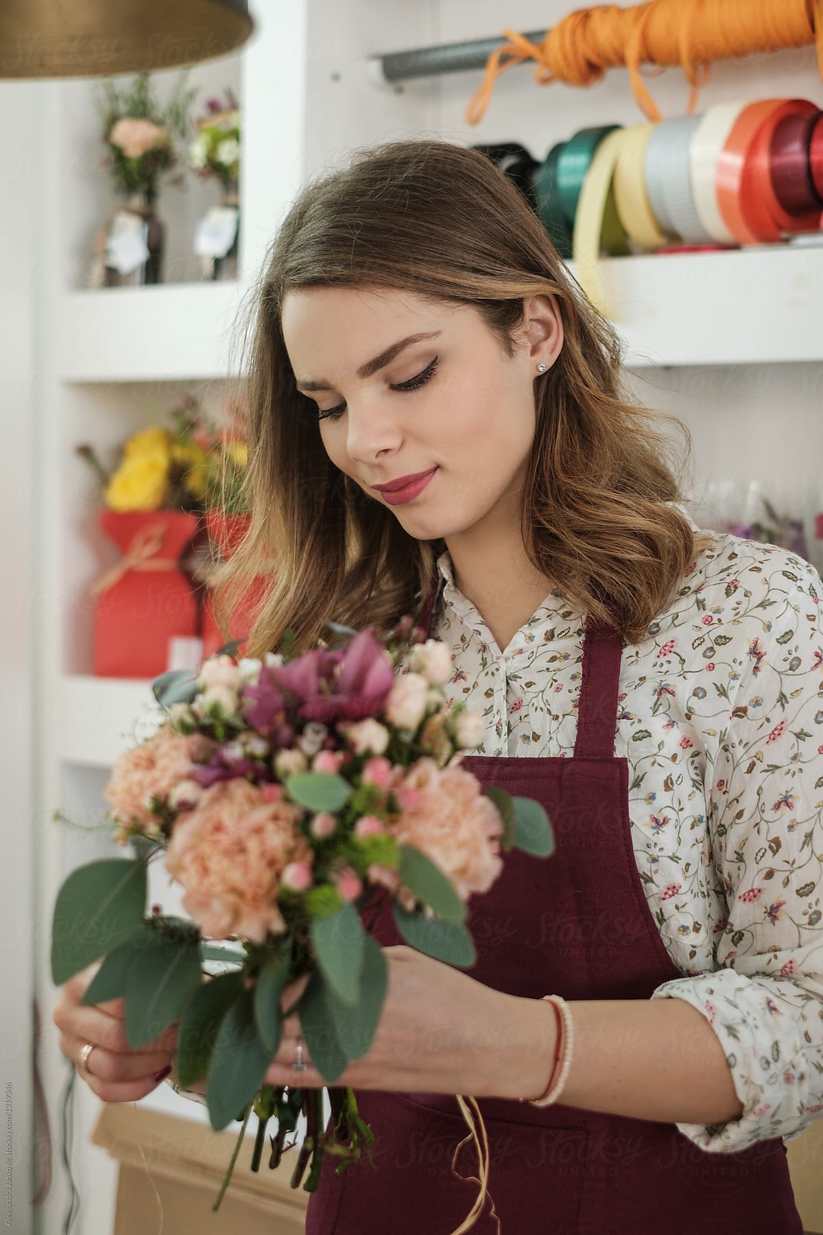 Female Florist Arranging Flowers At The Shop By Stocksy Contributor