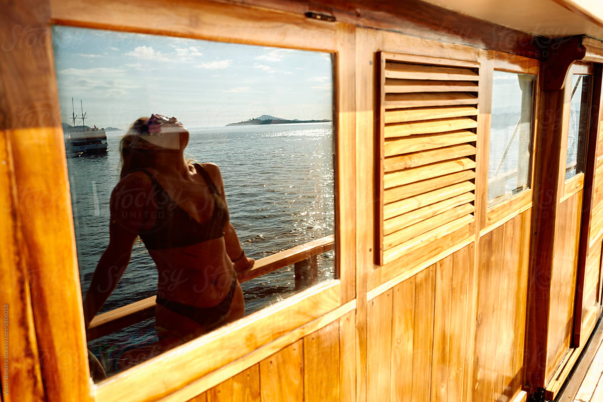 woman at a boat enjoying taking the sun