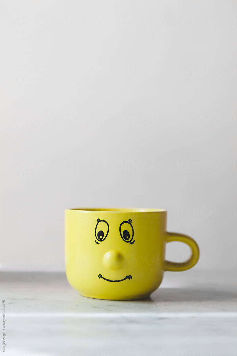 Funny Smiley Face on a Yellow Mug