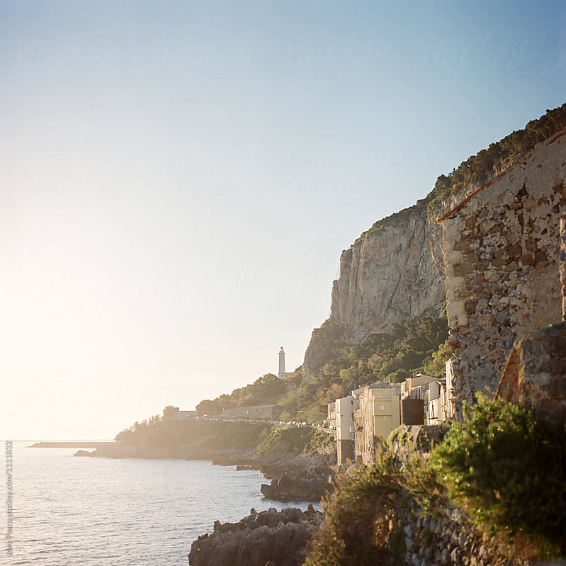 Cliffs and lighthouse at sunrise on the northern coast of Sicily