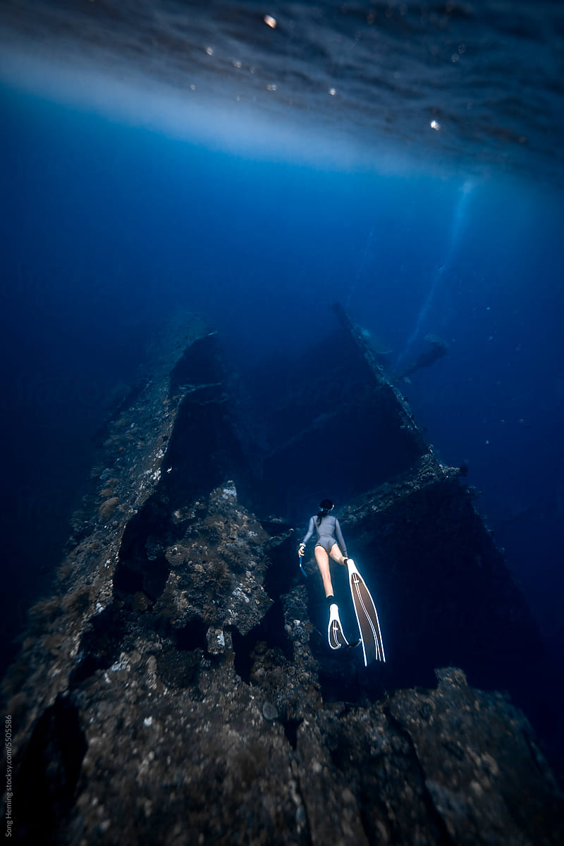 A female freediver diving with the USS Liberty Wreck Dive Site
