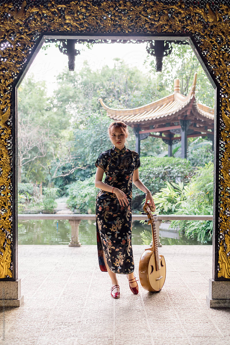 Asian young woman in cheongsam with a Chinese instruments zhongruan