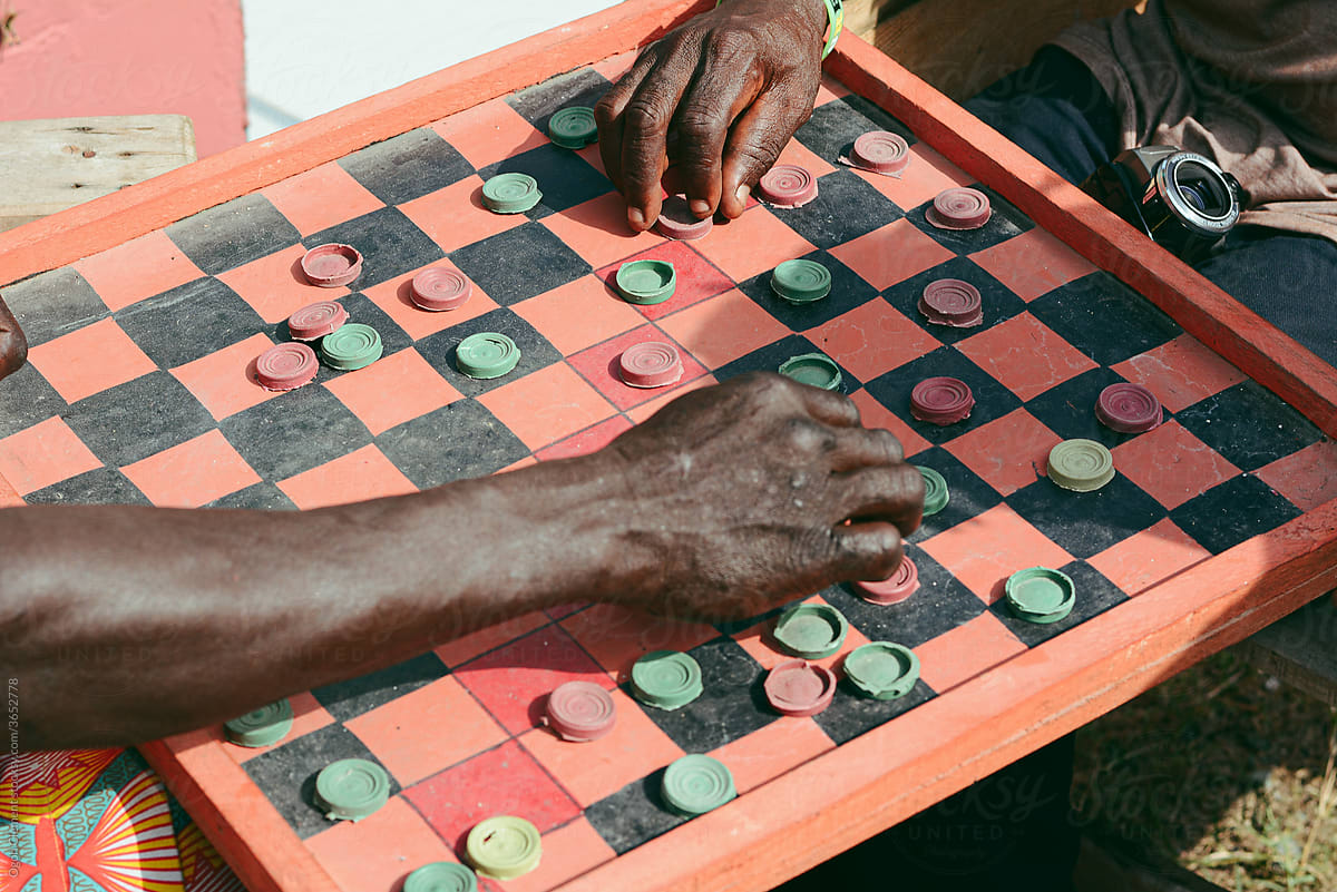 Men playing draughts board game