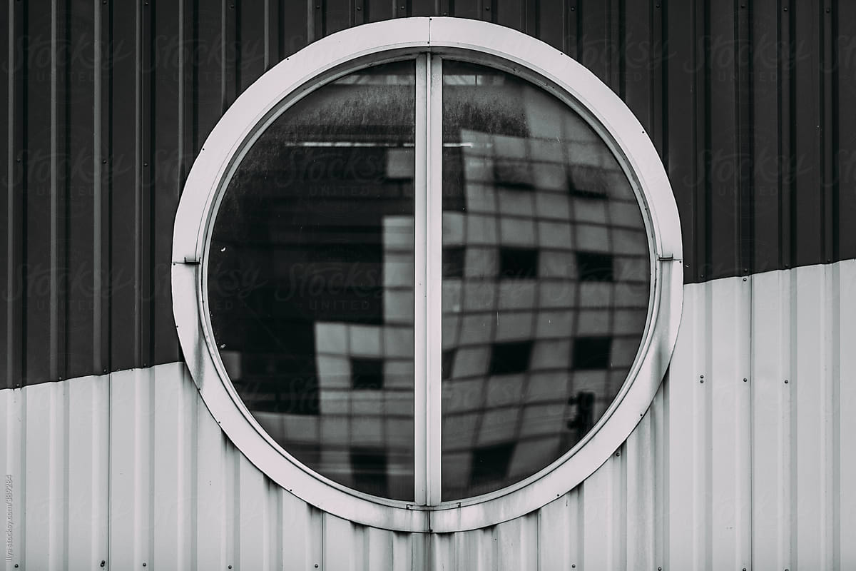 Black white abstract urban city building reflection round window