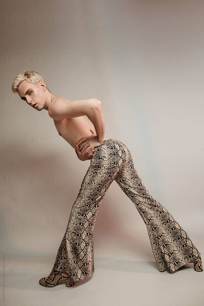 Slender crossdresser model in snake print pants