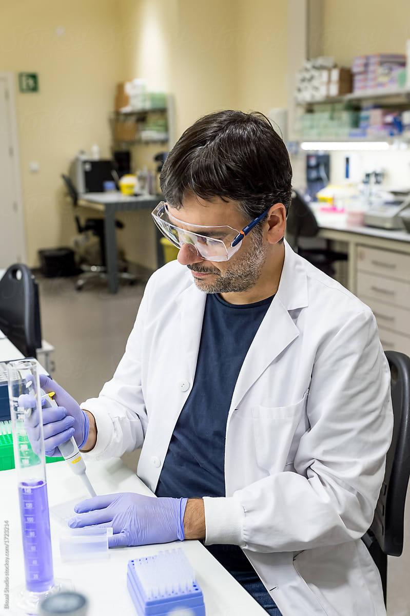 Male scientist using a pipette in a DNA laboratory