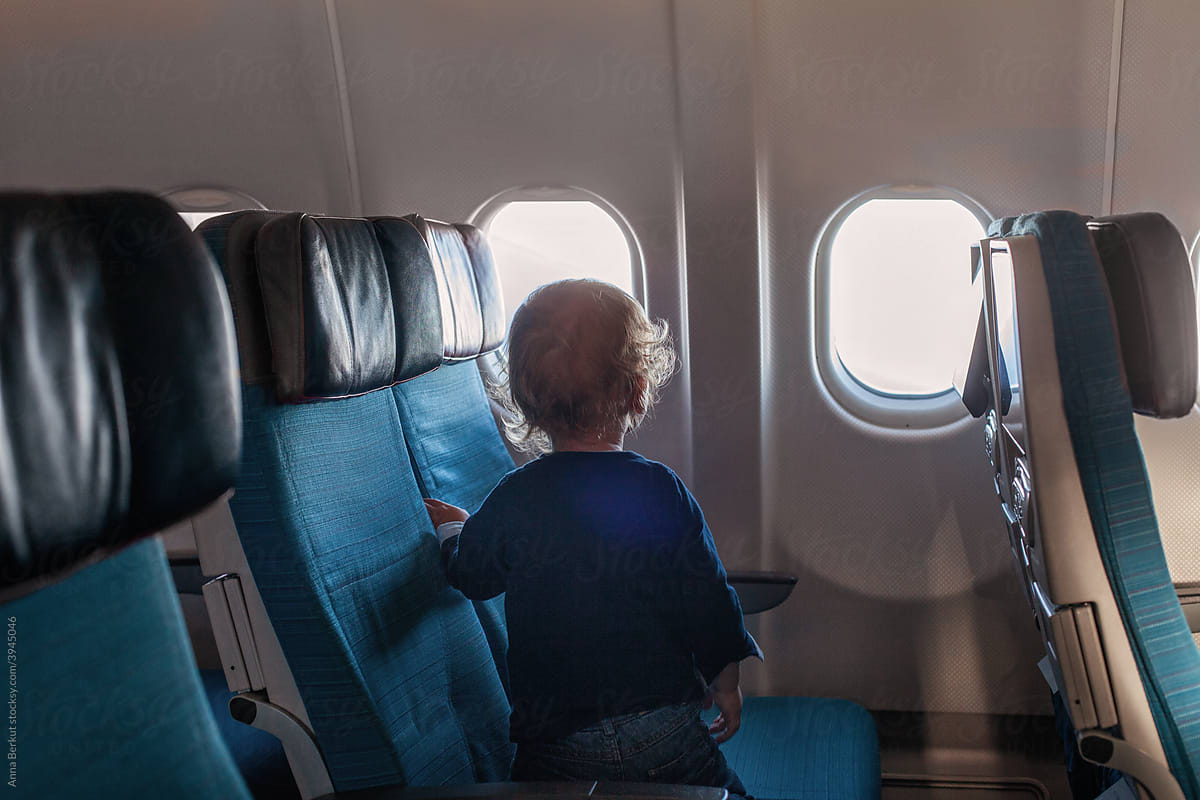 unrecognisable child in airplane, travel with  toddler