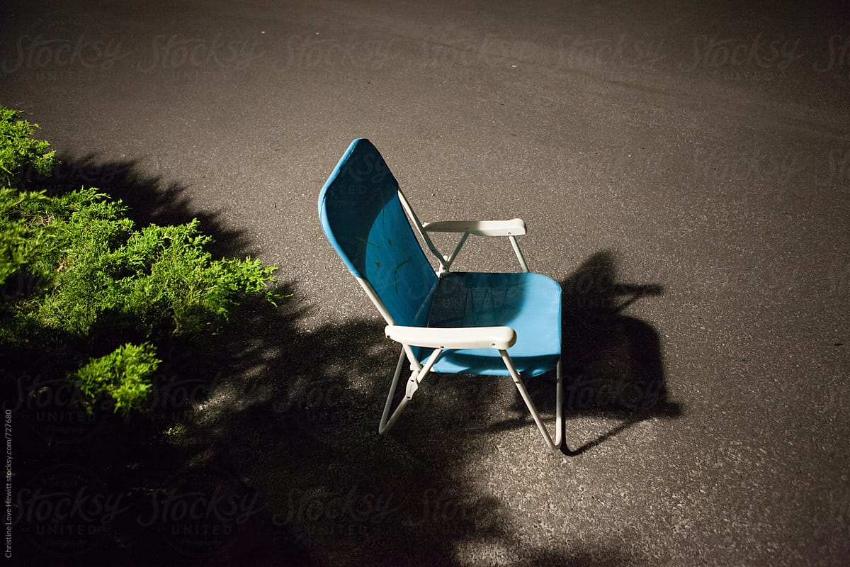 Chair in parking lot at night