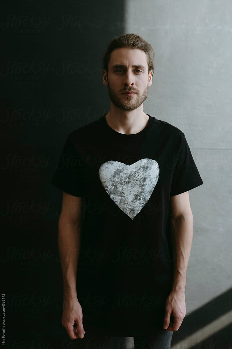 Modern male in black T-shirt with heart.