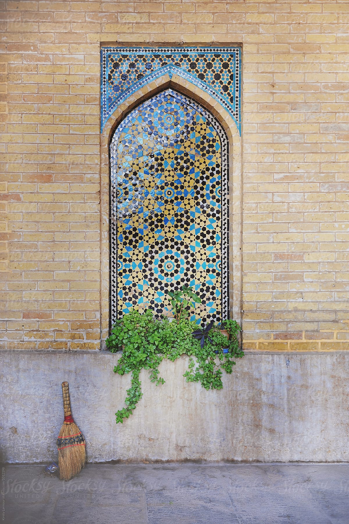 Decorative tiles and a broom inside a Mosque in iran
