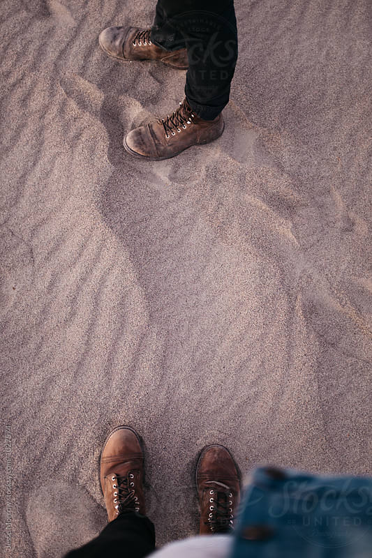 standing with brown boots looking down at ground human perspective