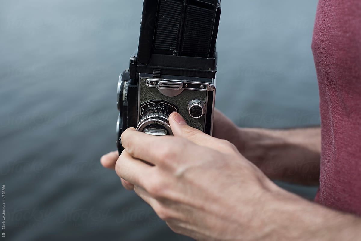 Close up of a man using an old vintage camera