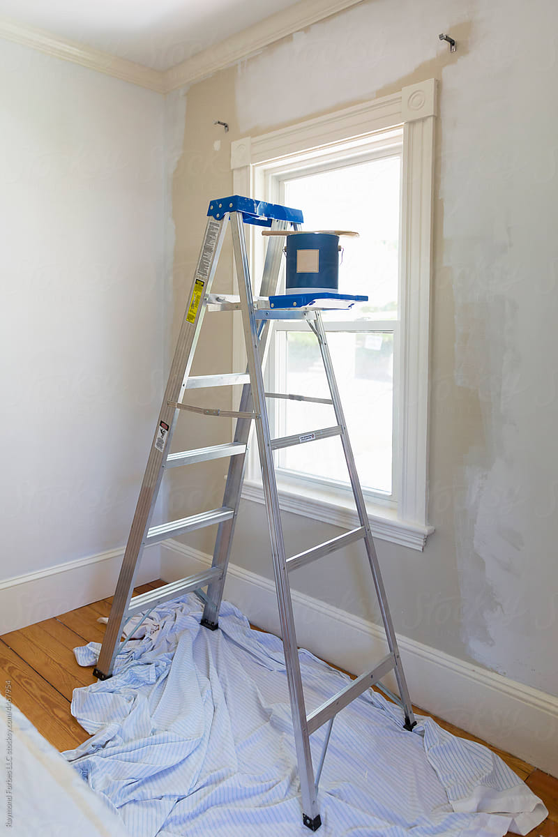 Home improvement painting room in home with ladder and paint can brush