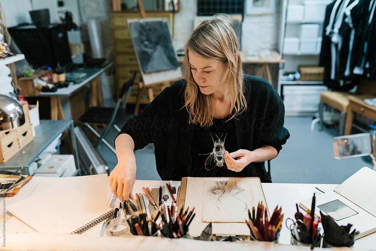 Female illustrator choosing pencil for drawing