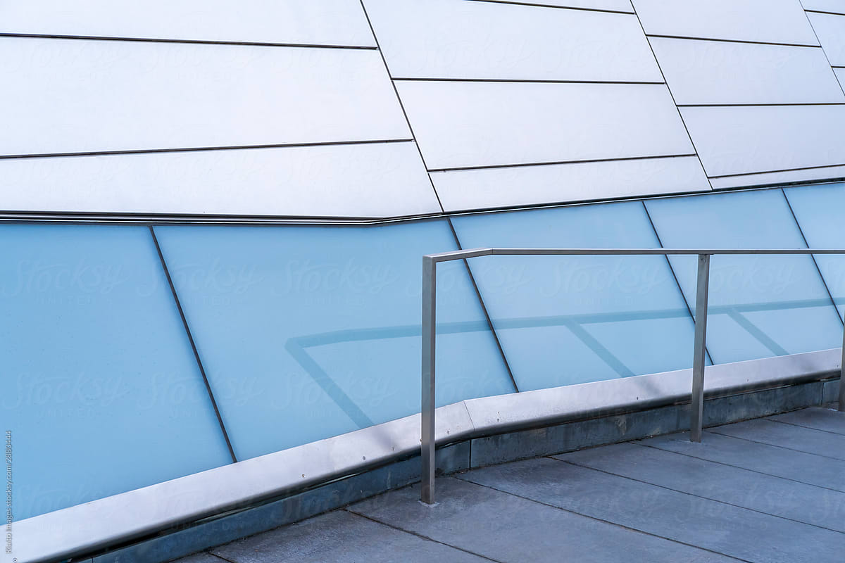 Detail of modern office building exterior, handrail and sidewalk