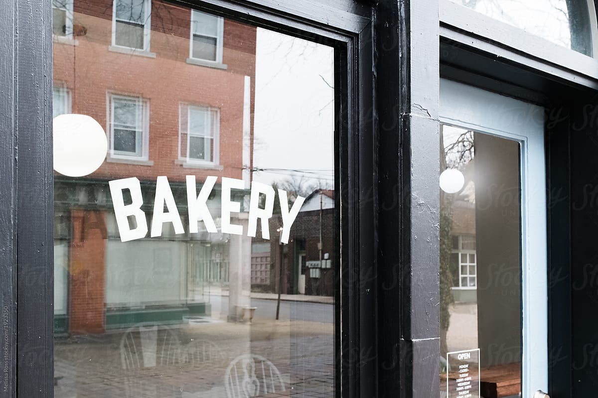 A store front window displaying the word Bakery.