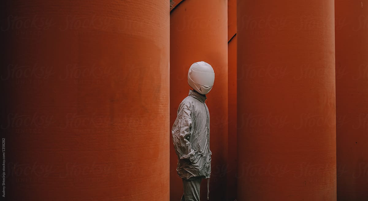 Abstract scene with person with white helmet/mask and silver jacket