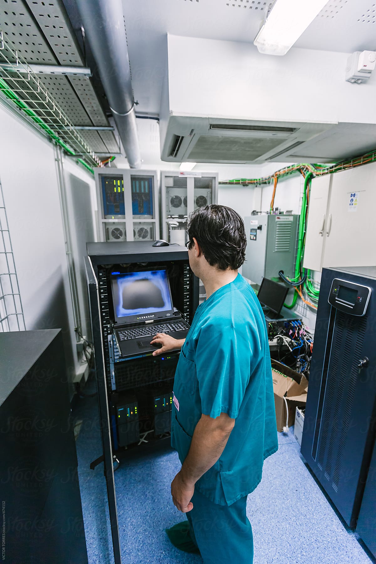 Assistant Checking the Servers of the Surgery Robotic Equipment