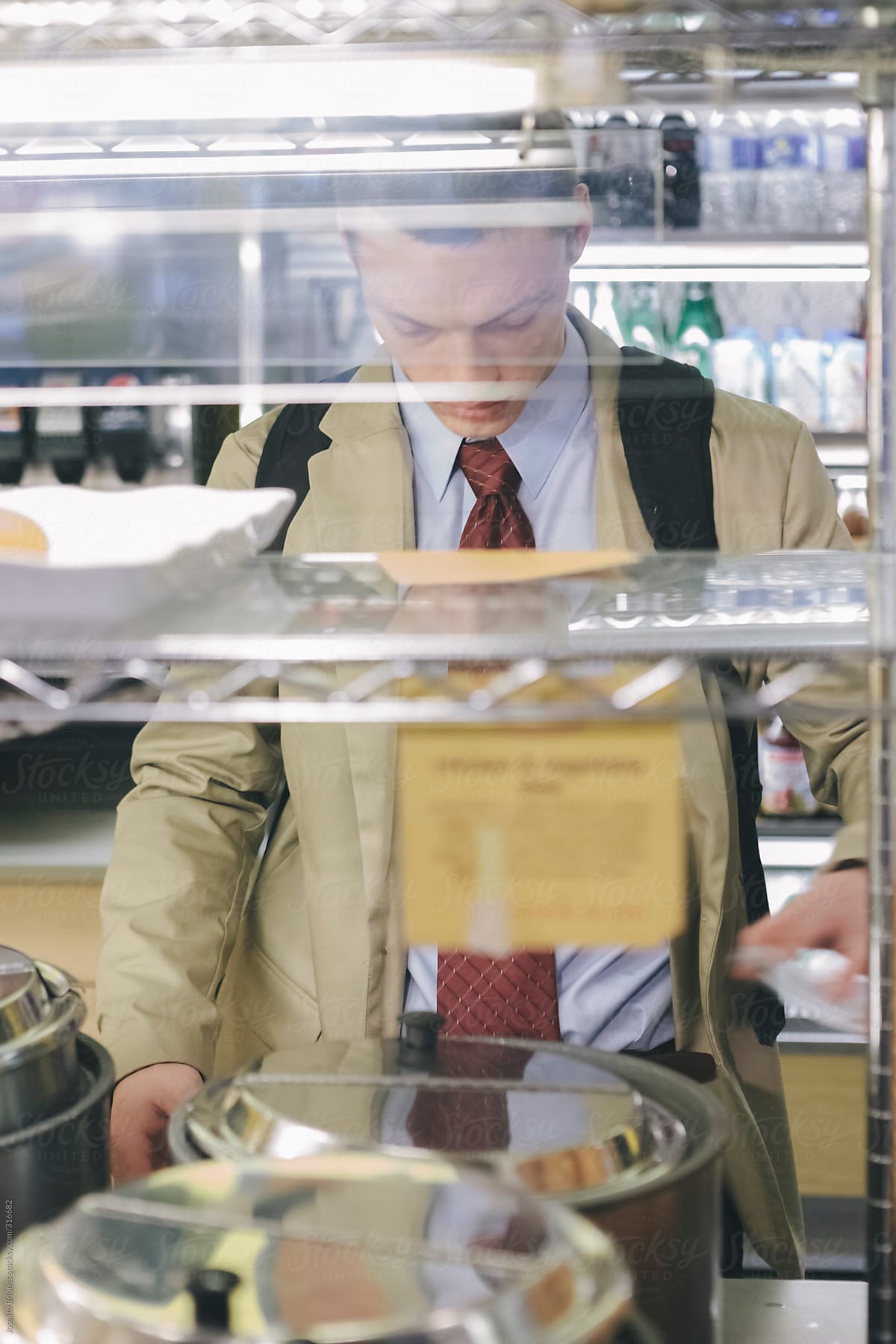 Young Professional Eating Quick Lunch in a Deli in New York's Wall Street Business District