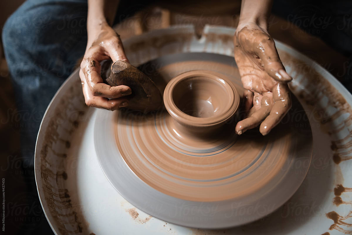 Female Potter Making Vase In Workshop With Natural Light