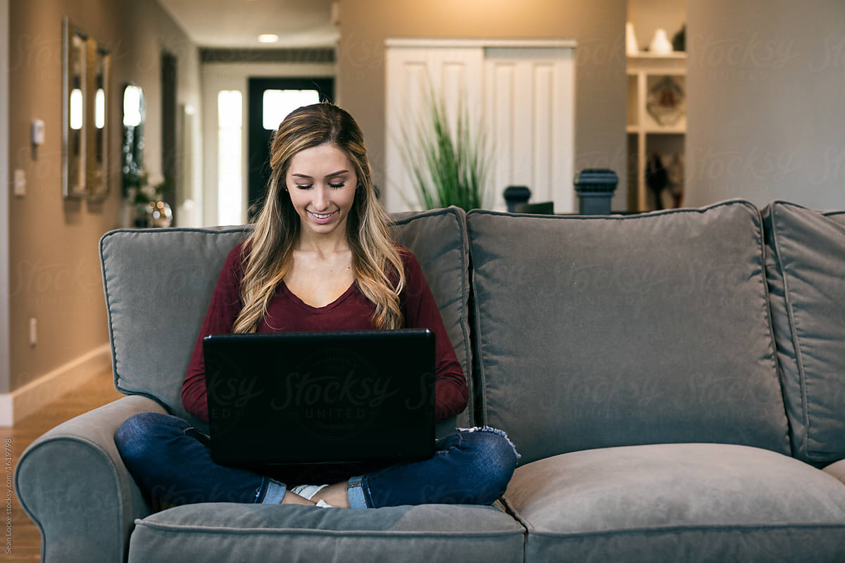 Home: College Student Sits On Couch With Laptop