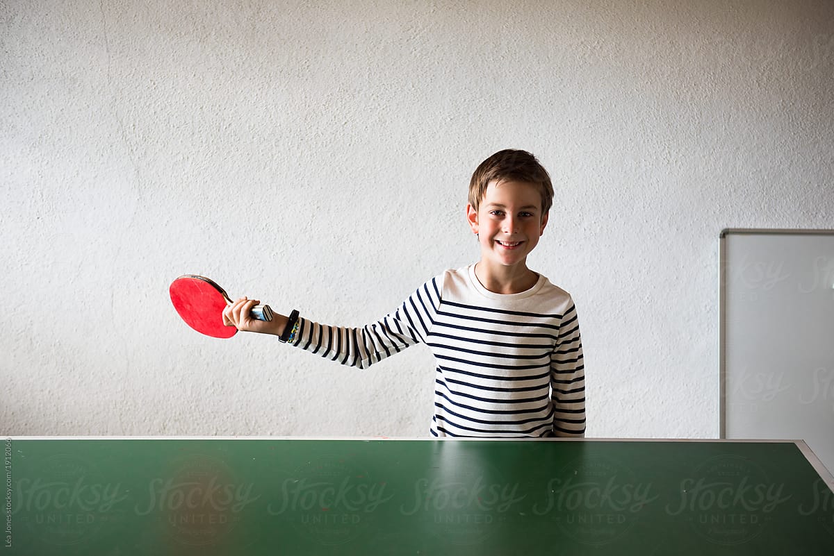little boy playing ping-pong / table tennis