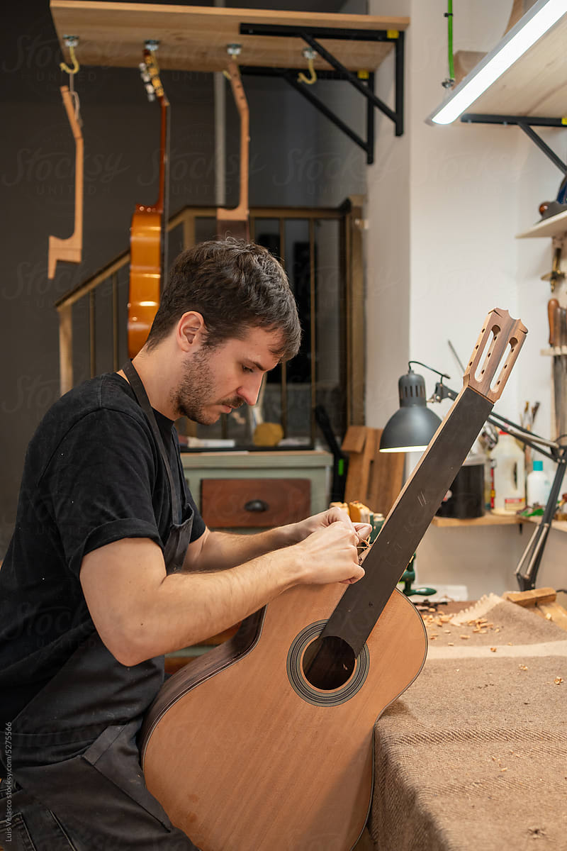 Luthier, Guitar Maker, Working In The Workshop.