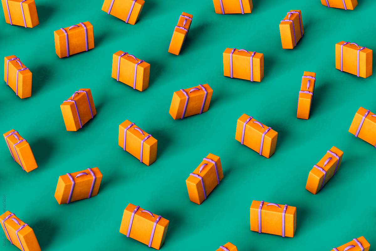 orange suitcases on green background in different posistions