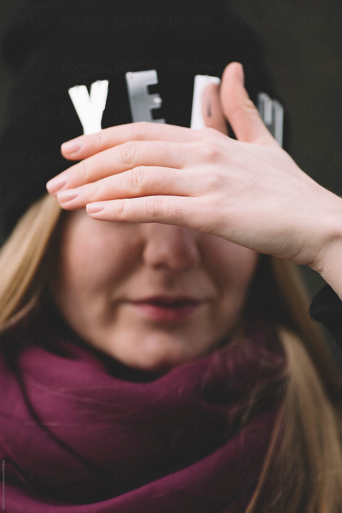young woman covering her face