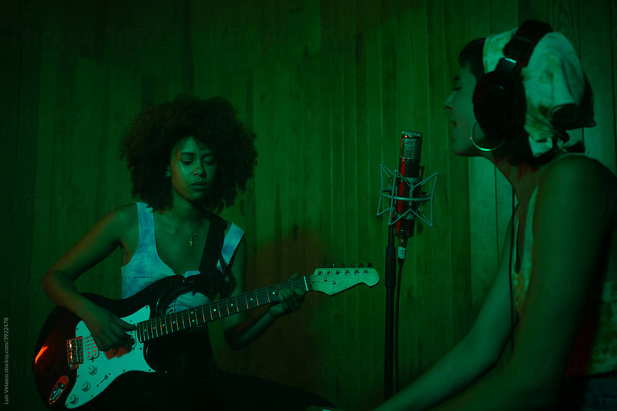 Women Musicians Playing Music In A Green Studio.