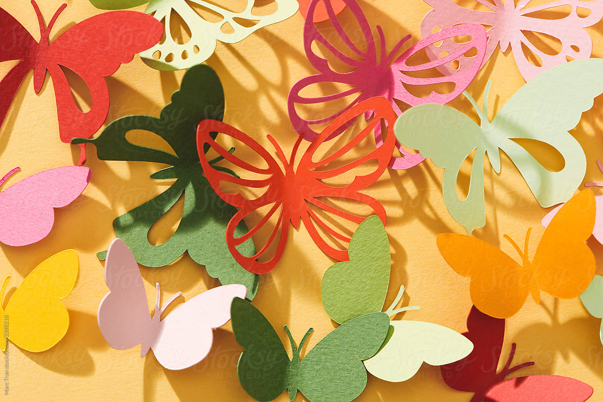 Paper cut out butterflies, on yellow background