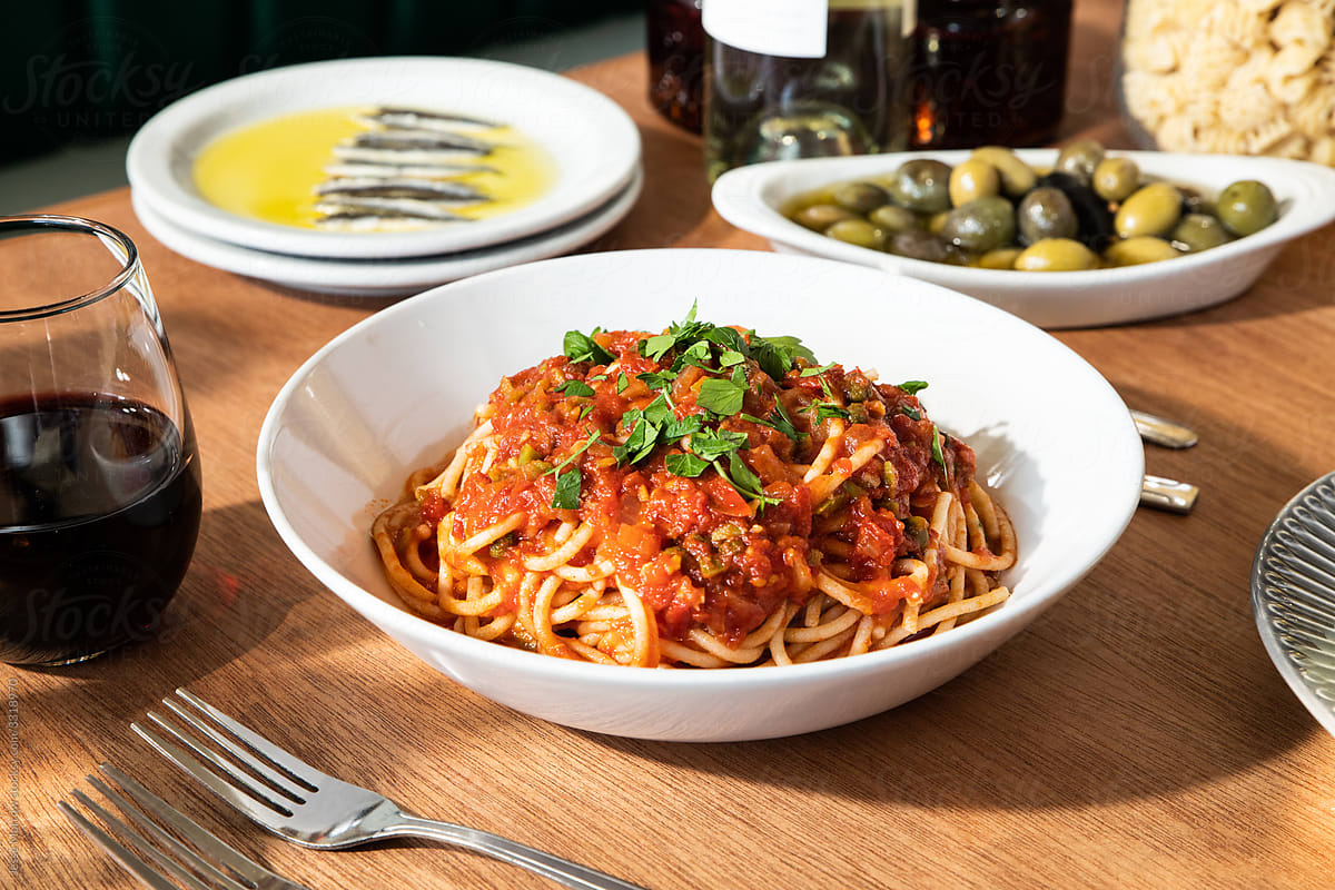 spaghetti puttanesca dish on table