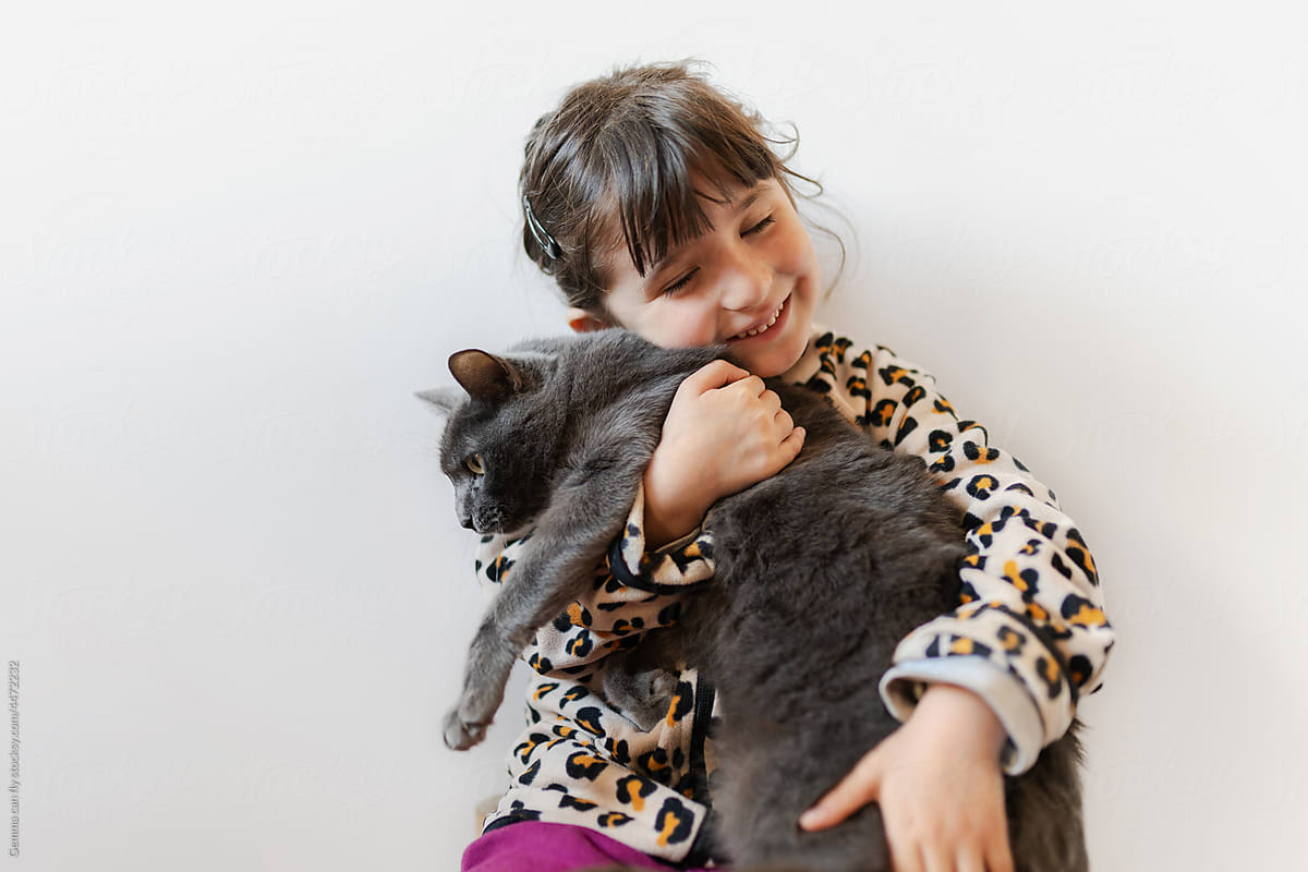 UGC, user-generated content. Happy girl holding a cat with love
