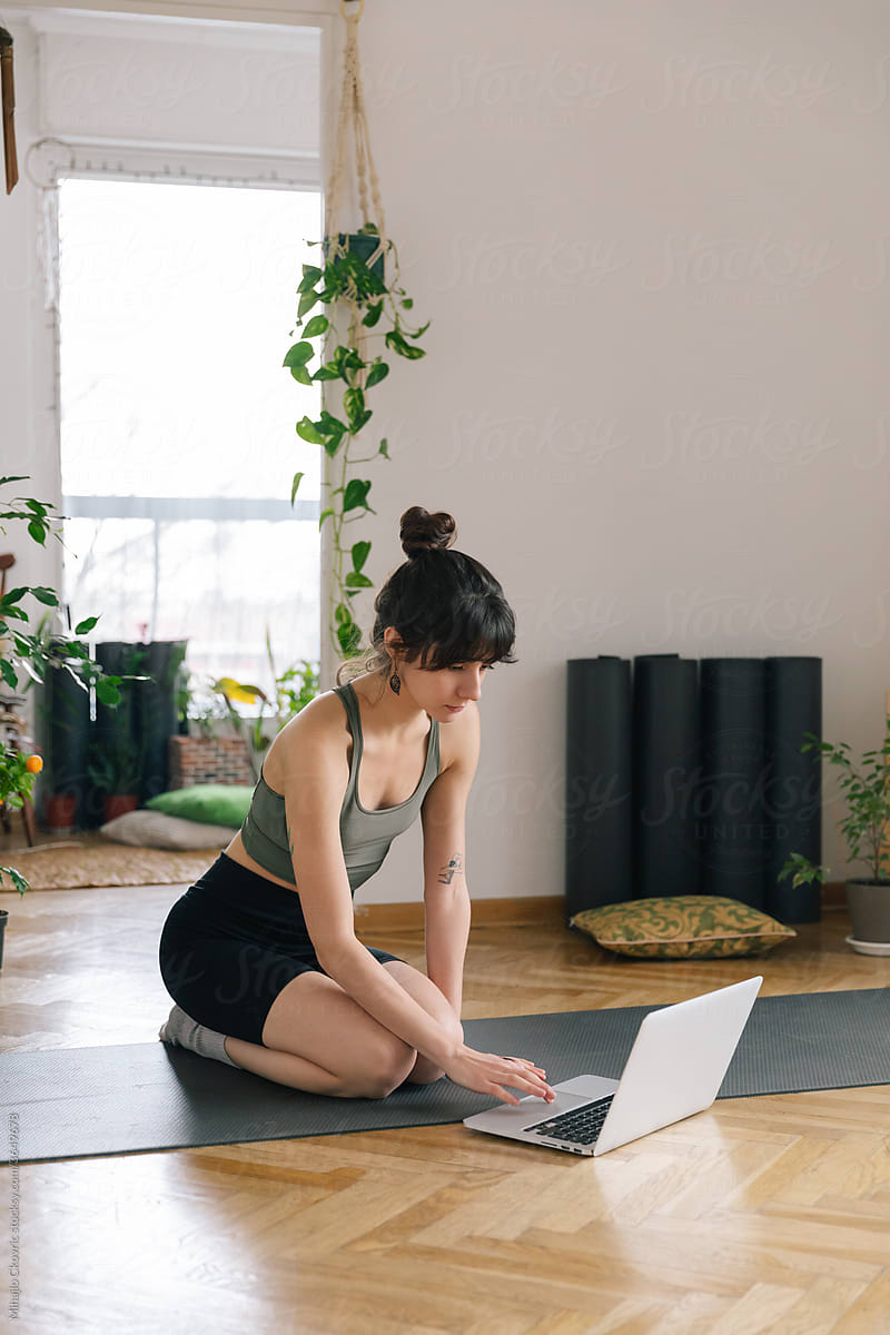 Woman Having An Online Yoga Class At Home