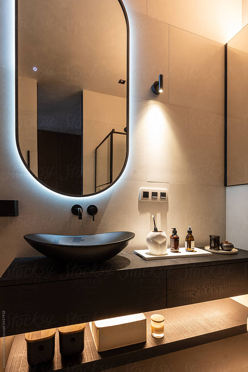 Bathroom cozy warm lighting, mirror, sink and handmade wood countertop