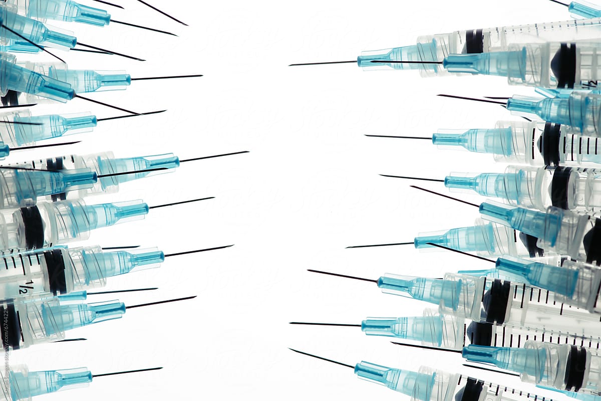 To group of medical hypodermic needles facing off.